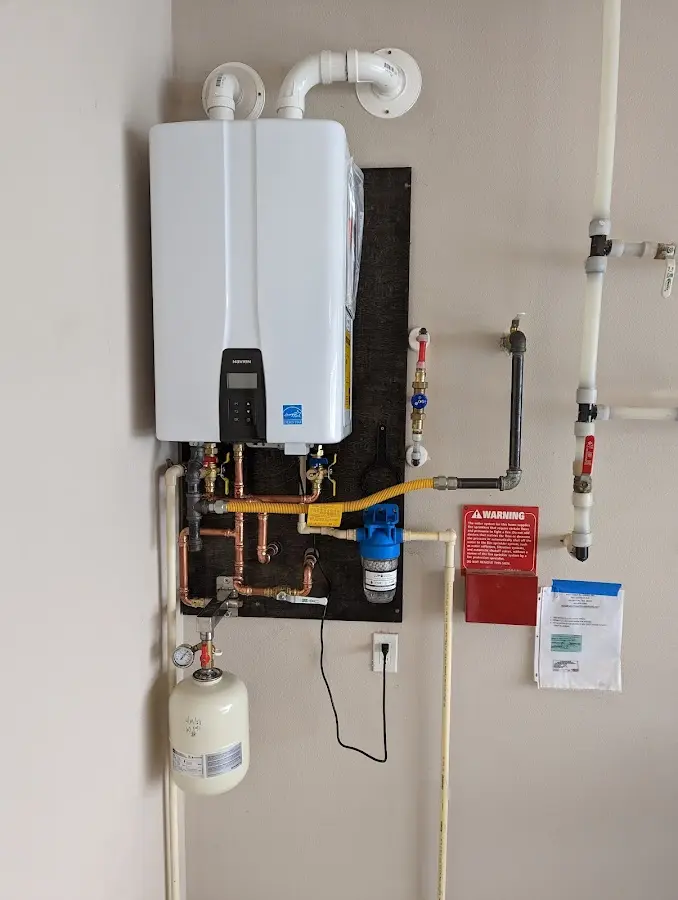 Professional plumber installing copper piping in a Ray home